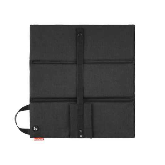The black heated seat cushion unfolded flat, with its carry handle, strap and h button.